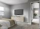 Spacious bedroom with large TV and access to exterior at 15963 W Montana De Oro Dr, Surprise, AZ 85387