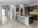 Open concept kitchen with island, dark cabinets and view into entryway at 15963 W Montana De Oro Dr, Surprise, AZ 85387