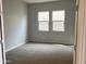 Spacious bedroom with carpet and two windows at 15963 W Montana De Oro Dr, Surprise, AZ 85387