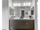 Double vanity bathroom with modern fixtures and large mirror at 15963 W Montana De Oro Dr, Surprise, AZ 85387