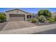 Single-story home with a two-car garage and nicely landscaped front yard at 17780 W Canto Bonito Ln, Surprise, AZ 85387