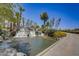 Landscaped waterfall and pond with palm trees at 17780 W Canto Bonito Ln, Surprise, AZ 85387