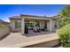 Large covered patio with seating area and grill, overlooking the backyard at 17780 W Canto Bonito Ln, Surprise, AZ 85387