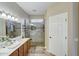 Bathroom with a walk-in shower and double vanity at 17780 W Canto Bonito Ln, Surprise, AZ 85387
