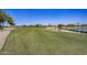 Landscaped golf course with a lake and homes visible at 17780 W Canto Bonito Ln, Surprise, AZ 85387