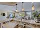 Kitchen features granite counters, double sinks, and breakfast bar overlooking living room at 17780 W Canto Bonito Ln, Surprise, AZ 85387