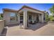 Spacious covered patio, adjacent to the house, with seating area at 17780 W Canto Bonito Ln, Surprise, AZ 85387