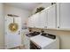Laundry room with washer, dryer, and cabinets at 17780 W Canto Bonito Ln, Surprise, AZ 85387