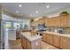 Modern kitchen with granite countertops, wood cabinets, and stainless steel appliances at 17780 W Canto Bonito Ln, Surprise, AZ 85387