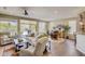 Open concept living area with wood floors and access to patio at 17780 W Canto Bonito Ln, Surprise, AZ 85387