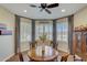 Charming dining area with bay window and wood floors at 17780 W Canto Bonito Ln, Surprise, AZ 85387