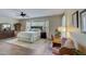 Main bedroom with large bed, dresser, and writing desk at 17780 W Canto Bonito Ln, Surprise, AZ 85387