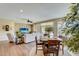 Bright dining area with wood table and chairs, hardwood floors, and access to kitchen at 17780 W Canto Bonito Ln, Surprise, AZ 85387