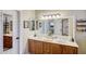 Double sink bathroom vanity with large mirror at 17780 W Canto Bonito Ln, Surprise, AZ 85387