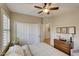 Bedroom with double doors and ceiling fan at 17780 W Canto Bonito Ln, Surprise, AZ 85387