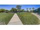 Concrete pathway meandering through a grassy community area at 17780 W Canto Bonito Ln, Surprise, AZ 85387