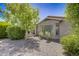Landscaped front yard with desert landscaping and trees at 17780 W Canto Bonito Ln, Surprise, AZ 85387