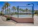 Well-maintained tennis court with surrounding fence at 17780 W Canto Bonito Ln, Surprise, AZ 85387
