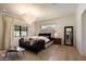 Main bedroom with large window, chandelier, and comfortable seating area at 6044 E Calle Del Paisano --, Scottsdale, AZ 85251