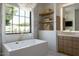 Spa-like bathroom featuring a soaking tub and a large window at 6044 E Calle Del Paisano --, Scottsdale, AZ 85251