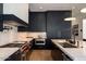 Modern kitchen featuring dark cabinetry, marble countertops, and high-end appliances at 6044 E Calle Del Paisano --, Scottsdale, AZ 85251
