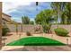 Landscaped backyard with putting green, water feature, and mature plants at 2074 E Hulet Pl, Chandler, AZ 85225