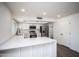 Modern kitchen with white shaker cabinets, quartz countertops, and stainless steel appliances at 17207 N 36Th St, Phoenix, AZ 85032