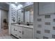 Modern bathroom with double vanity, updated fixtures, and patterned wallpaper at 9624 E Thunderbolt Ave, Mesa, AZ 85212