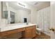 Clean bathroom with a shower/tub combo and wood cabinets at 11105 W Ashley Chantil Dr, Surprise, AZ 85378