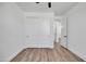 Bedroom featuring wood-look flooring, white walls, and double sliding closet doors at 588 N 350Th Dr, Tonopah, AZ 85354