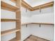 Spacious walk-in closet with built-in wooden shelving and hanging rods at 588 N 350Th Dr, Tonopah, AZ 85354