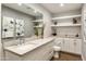 Modern bathroom with floating shelves, a vanity with a quartz countertop, and toilet at 9030 N 48Th Pl, Paradise Valley, AZ 85253