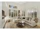 Bright living room featuring a sectional sofa, coffee table, and large windows at 9030 N 48Th Pl, Paradise Valley, AZ 85253
