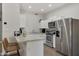 Modern kitchen with white cabinets, stainless steel appliances, and an island at 9030 N 48Th Pl, Paradise Valley, AZ 85253