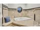 Relaxing bathroom with a soaking tub and a round window at 9030 N 48Th Pl, Paradise Valley, AZ 85253