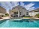 Spacious backyard with a kidney-shaped pool and covered patio at 3882 W Alabama Ln, San Tan Valley, AZ 85144