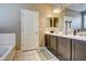 Double vanity bathroom with dark brown cabinets and a soaking tub at 3882 W Alabama Ln, San Tan Valley, AZ 85144