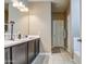 Double vanity bathroom with dark brown cabinets and tile floors at 3882 W Alabama Ln, San Tan Valley, AZ 85144