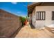 Side yard with a block wall and vegetation at 1505 W Fillmore St, Phoenix, AZ 85007