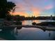 Stunning sunset view over lake, visible from the backyard pool at 3406 E Wildwood Dr, Phoenix, AZ 85048