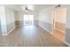 Light-filled living room with wood-look floors and sliding door access at 8702 E Boise St, Mesa, AZ 85207