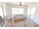 Bright sunroom with tile floors, sliding glass doors, and a comfy sofa at 8702 E Boise St, Mesa, AZ 85207