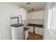 Updated laundry room with cabinets and a water heater at 8702 E Boise St, Mesa, AZ 85207