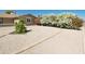 Landscaped front yard with blooming flowers and gravel at 8702 E Boise St, Mesa, AZ 85207