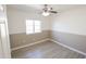 Spacious bedroom with ceiling fan and large window at 8702 E Boise St, Mesa, AZ 85207
