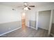Bedroom with ceiling fan, closet and door to hallway at 8702 E Boise St, Mesa, AZ 85207