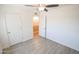 Bright bedroom with ceiling fan and double doors to closet at 8702 E Boise St, Mesa, AZ 85207
