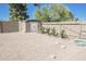 Landscaped backyard featuring gravel, storage shed, and small plants at 8702 E Boise St, Mesa, AZ 85207