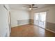 Bedroom with tile floors, ceiling fan and sliding glass door to patio at 8702 E Boise St, Mesa, AZ 85207