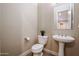 Small bathroom with pedestal sink, toilet, and mirror at 15817 W Bonitos Dr, Goodyear, AZ 85395